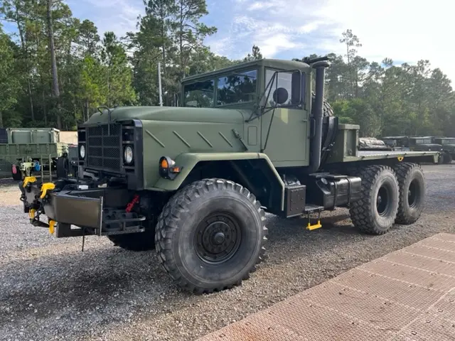 Six-wheel tractor truck parked on gravel