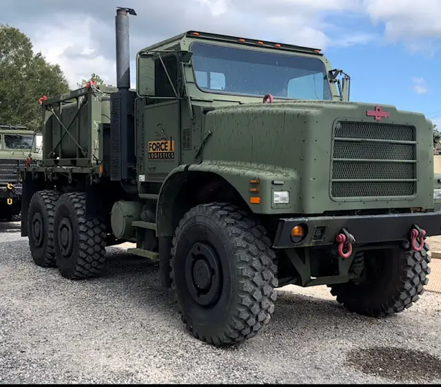 Large six-wheel truck parked on gravel