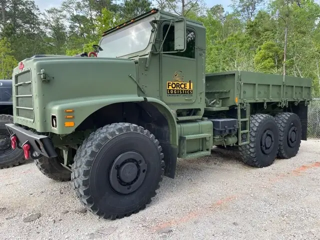 Six-wheel truck with a flatbed at the yard