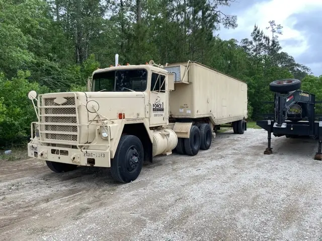 Tan tractor truck pulling a box trailer