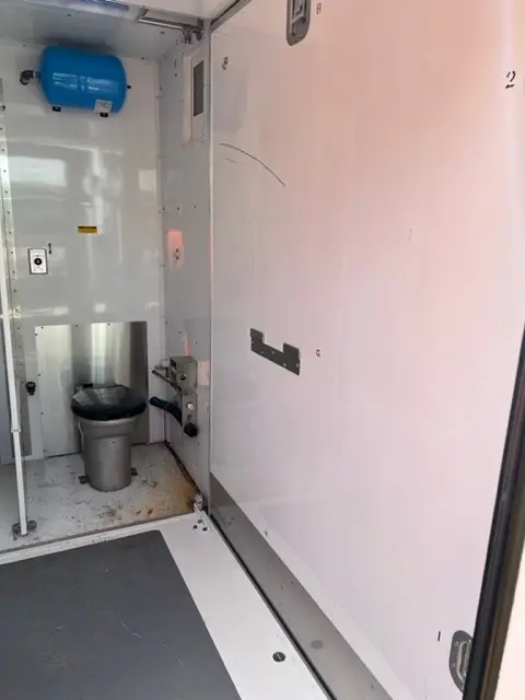 Toilet stall inside a restroom trailer