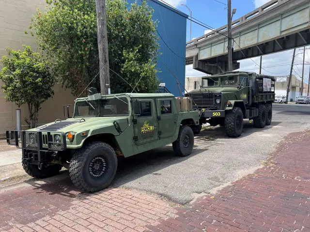 Force 1 utility vehicle and six-wheel truck parked under an overpass in New Orleans
